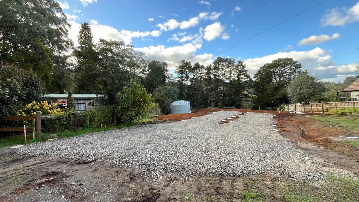 Completed crushed rock driveway with fresh gravel and rock edging
