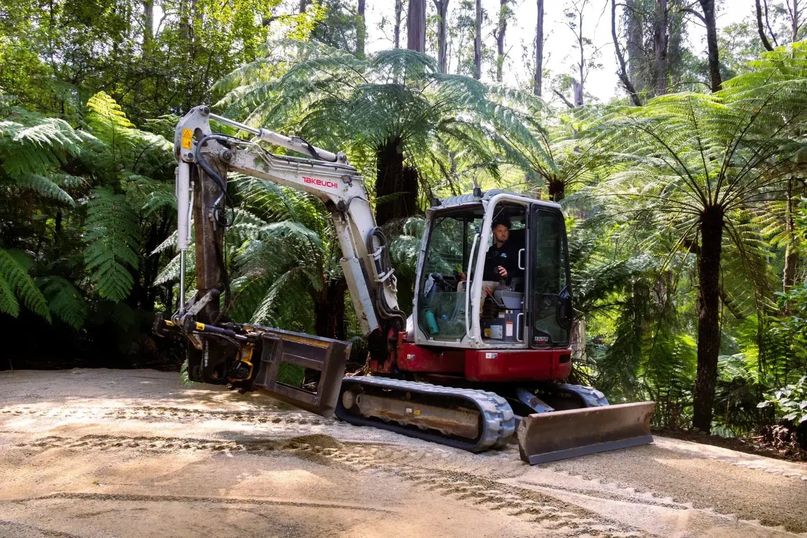 Takeuchi TB257FR excavator with Engcon tilt rotator on a crushed rock site in the Dandenong Ranges